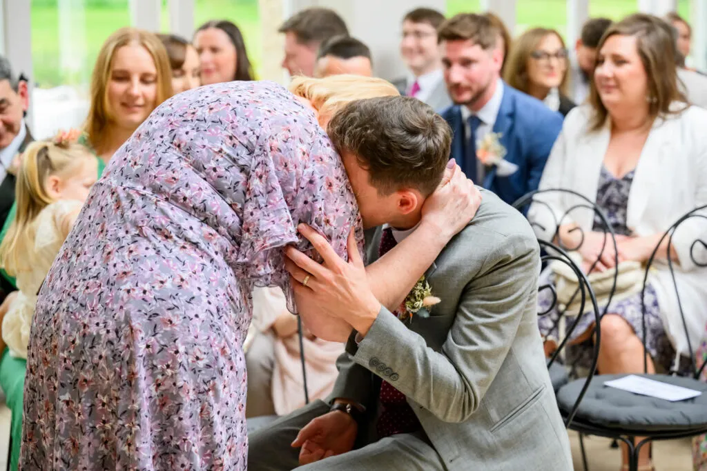 wedding guests reacting during ceremony woodborough hall orangery