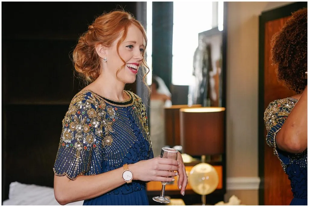 bridesmaid having a drink during bridal prep