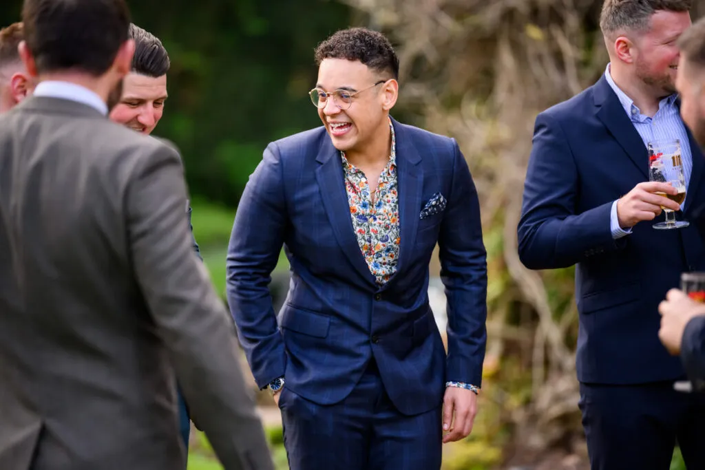 guests laughing together during drinks reception woodborough hall wedding