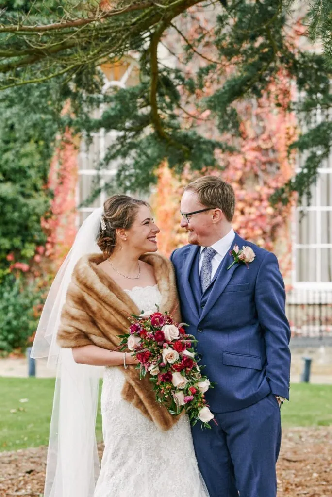 Happy bride and groom smiling outside during their winter wedding at Beaumont Estate