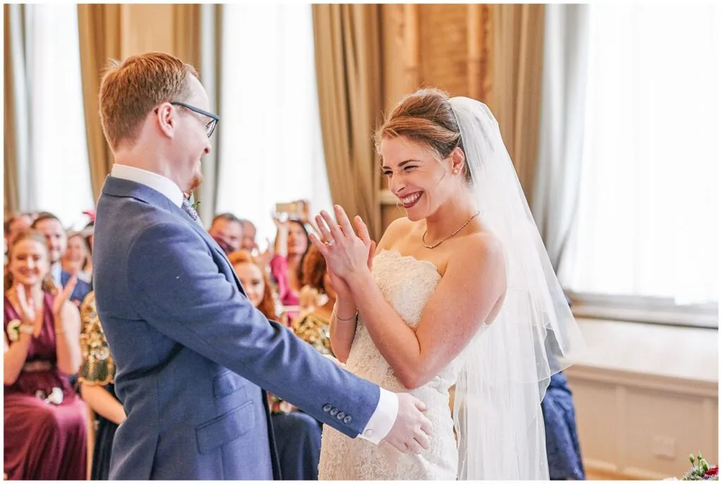Bride and groom smiling during their wedding ceremony at the Beaumont Estate