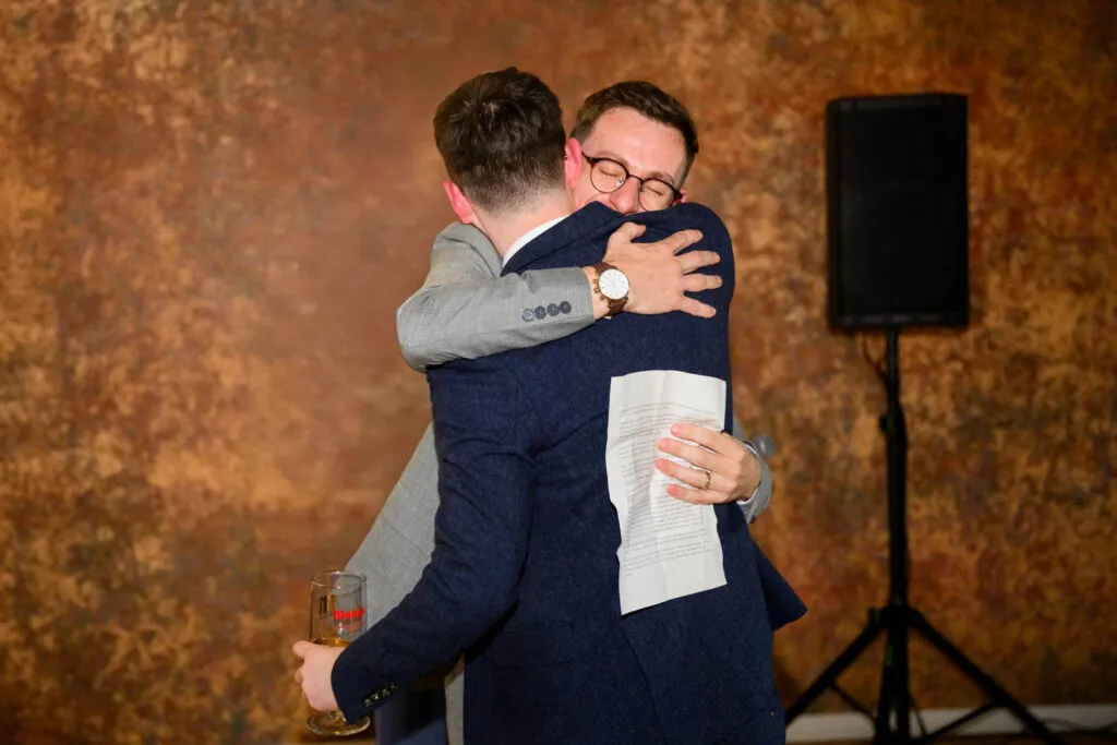 groom hugging brother during emotional speech woodborough hall