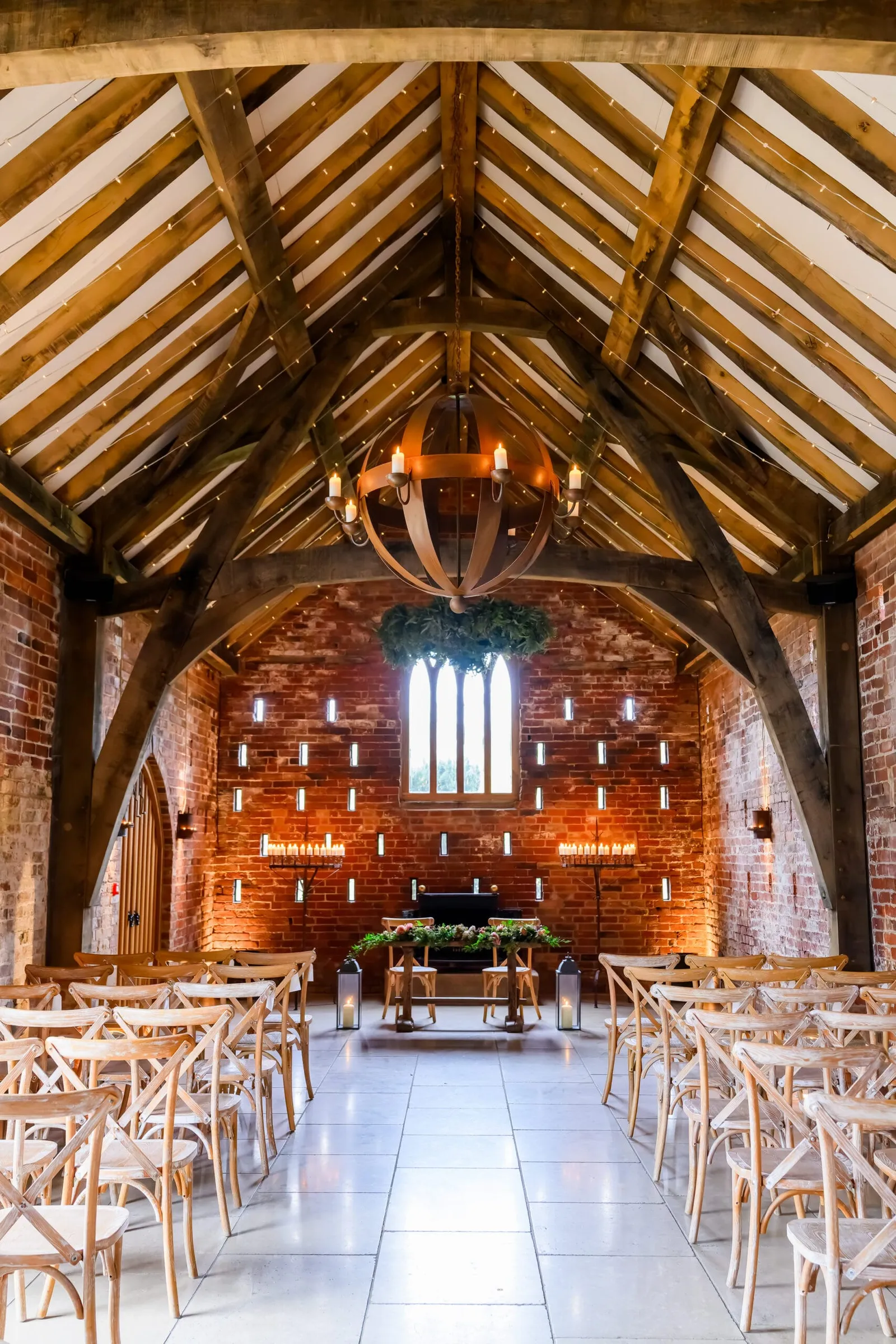 wedding ceremony room with brick walls and wooden beams at Grangefields Barn