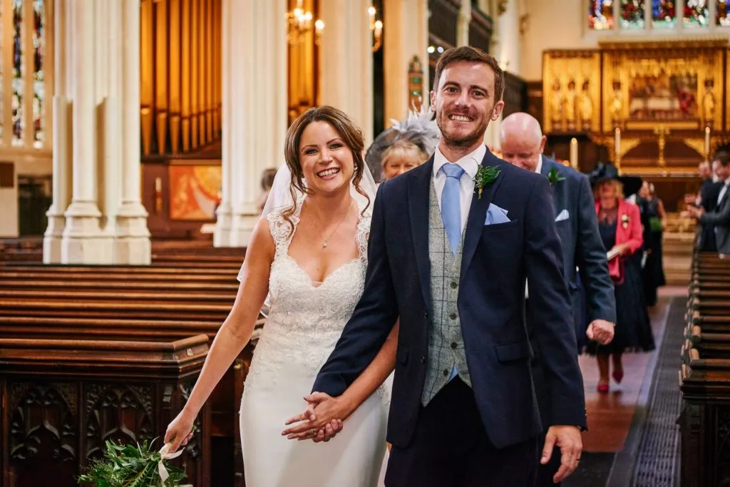 Bride and groom smiling together in St Margret's Church in London