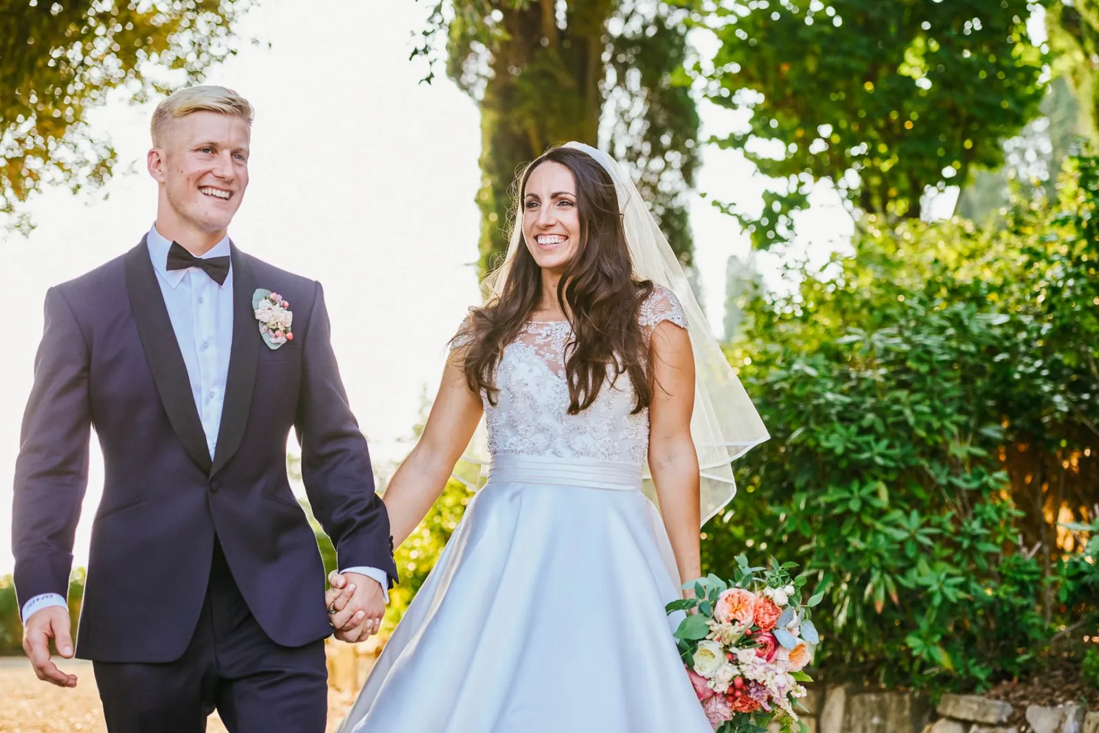Wedding couple holding hands during sunset at Villa Le Fontanelle in Italy