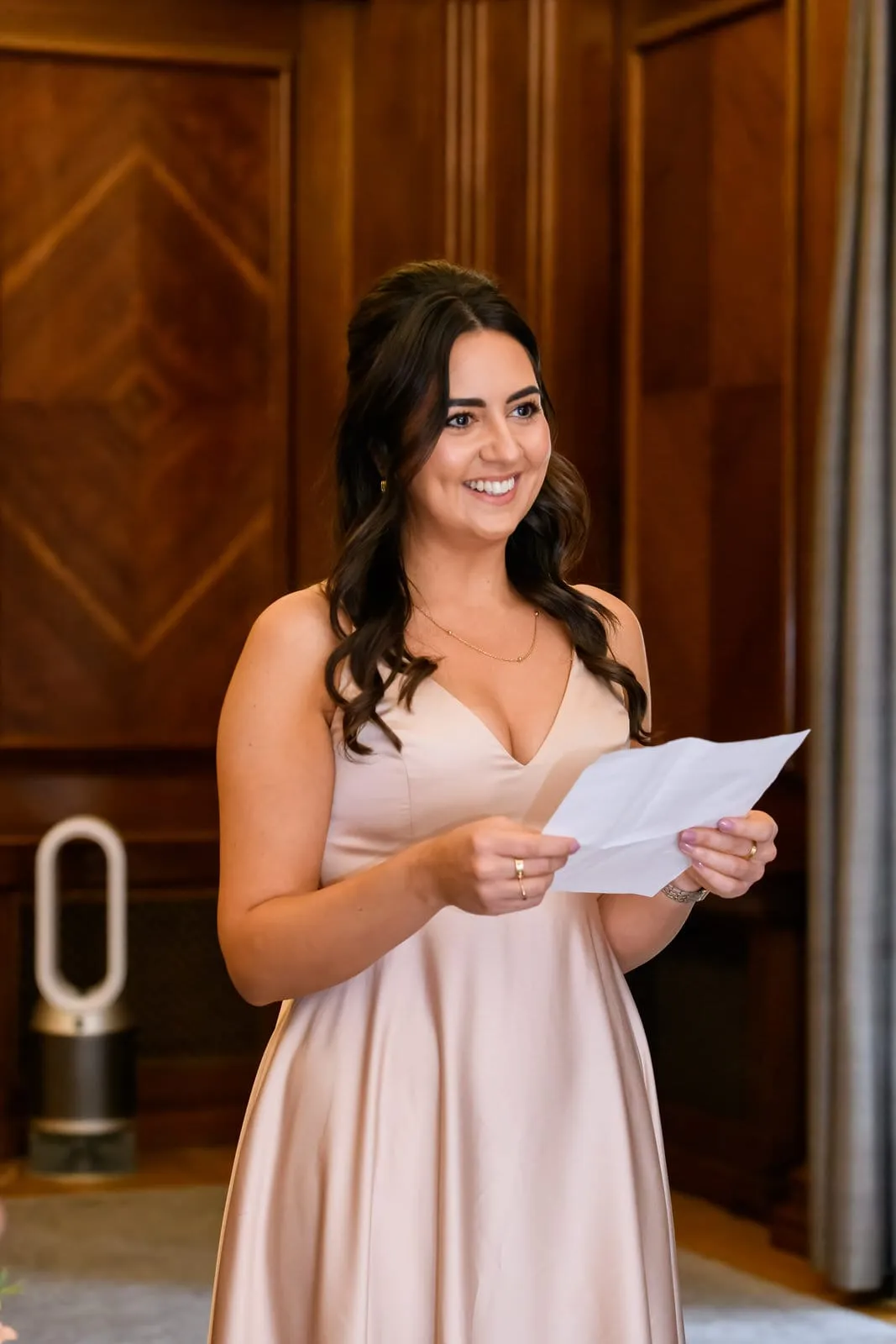 Bridesmaid smiling whilst giving a reading during London wedding