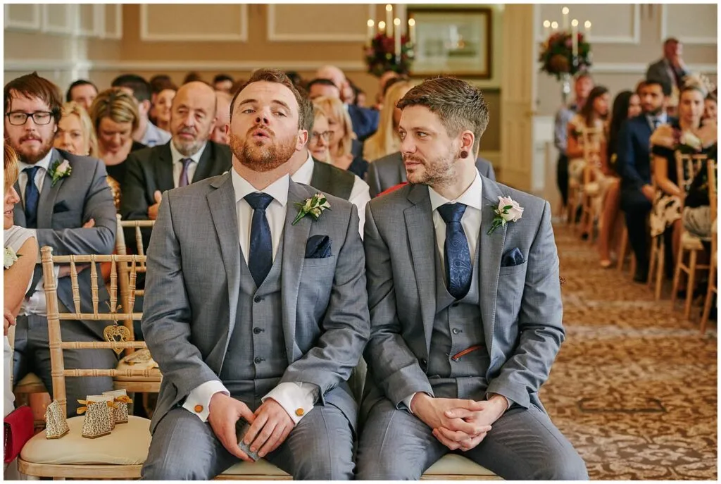 nervous best man and usher sat during wedding ceremony at Beaumont Estate