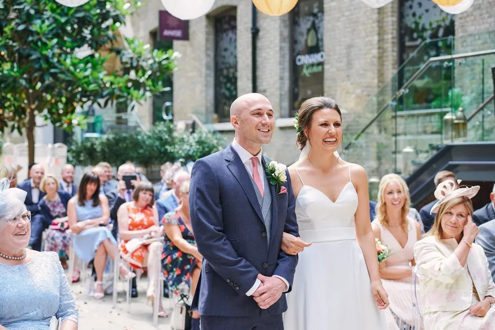 Bride and groom kissing during wedding ceremony at Devonshire Terrace in central London