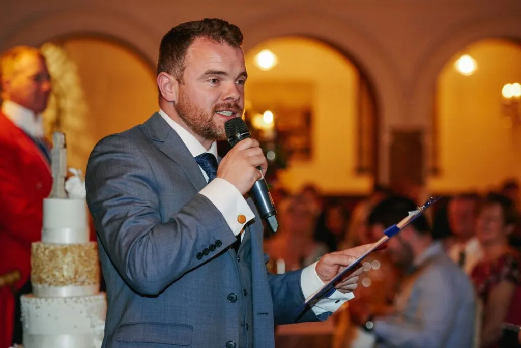 Best man giving a speech during fun winter wedding