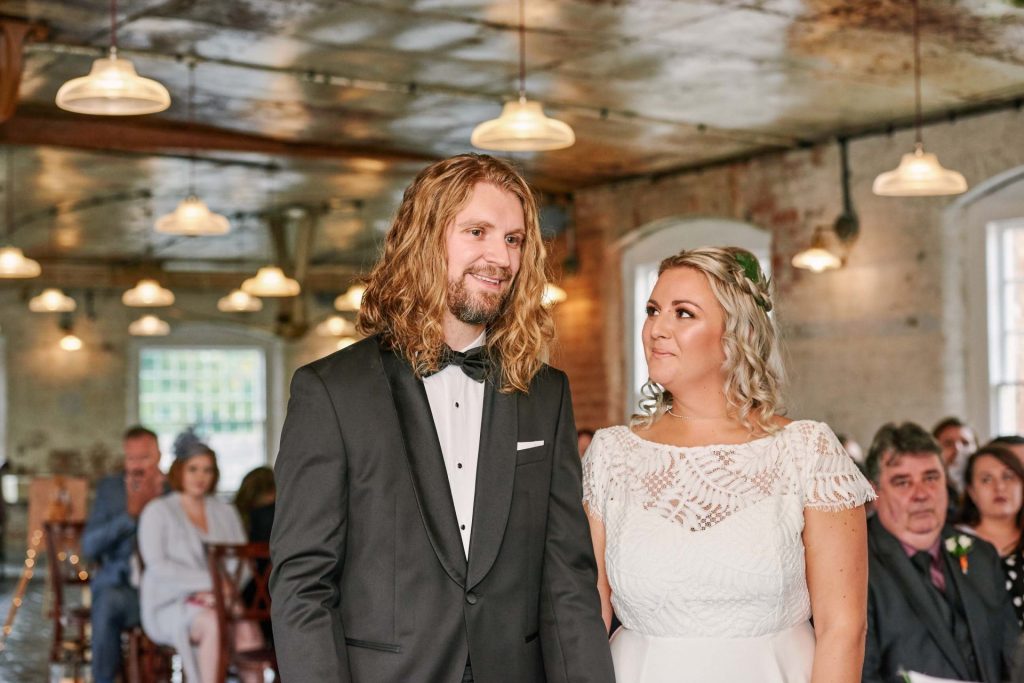 Colourful wedding photography of bride and groom laughing on sunny day