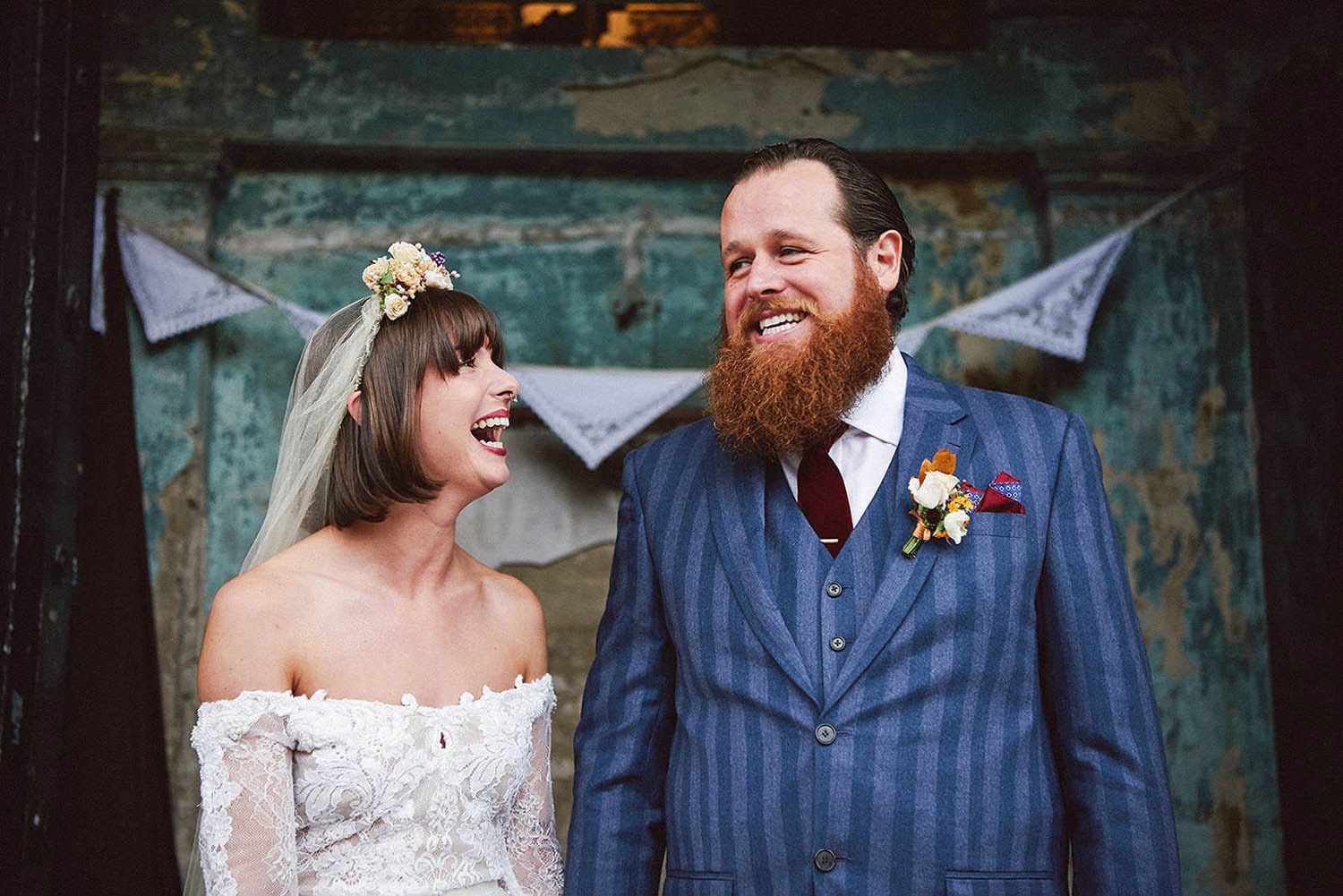 Nottingham Wedding Photography bride and groom laughing in front of colourful decaying background